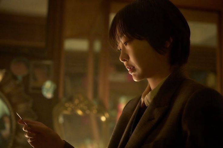 Kim Da-mi as Yoon E-na examining a clue in Nine Puzzle Kdrama thriller scene.